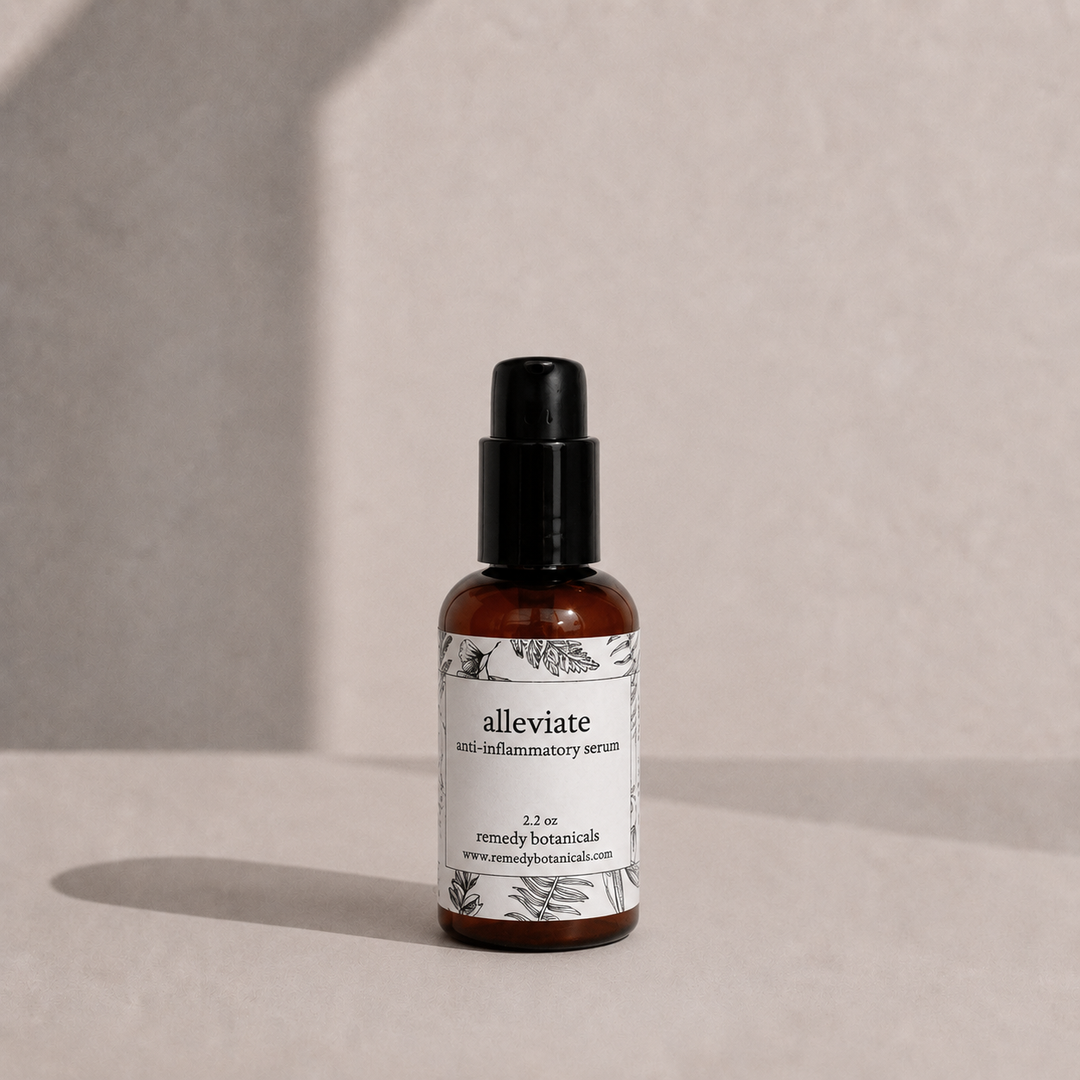 A small amber plastic dropper bottle labeled 'alleviate' by Remedy Botanicals, standing on a light beige surface.