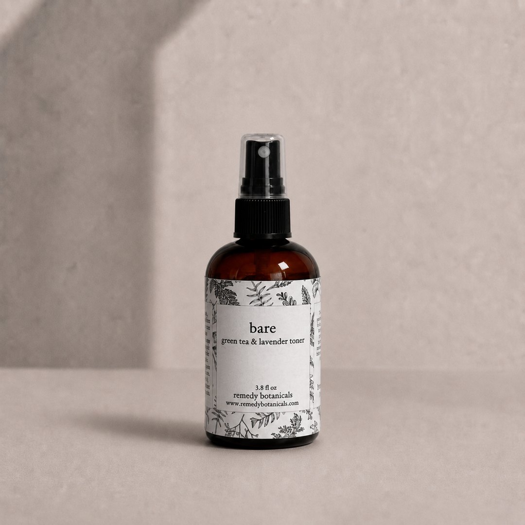 Bare in an amber plastic spray bottle on a soft beige background.