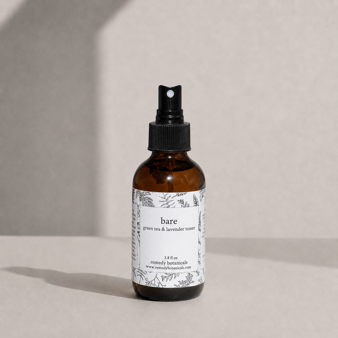 Bare in an amber spray bottle on a soft beige background.