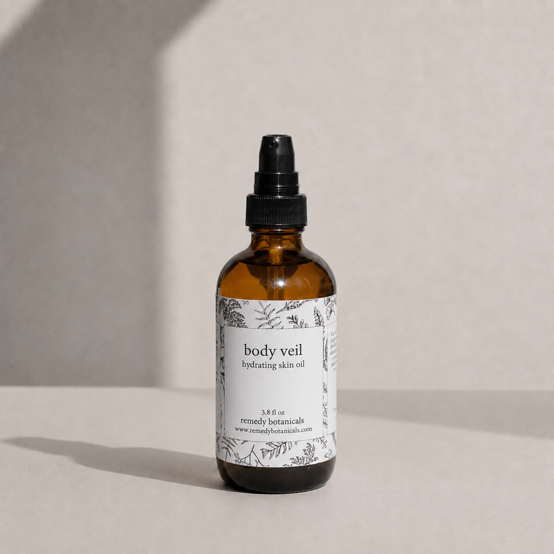 body veil amber glass spray bottle on a soft beige background with natural light and gentle shadows.