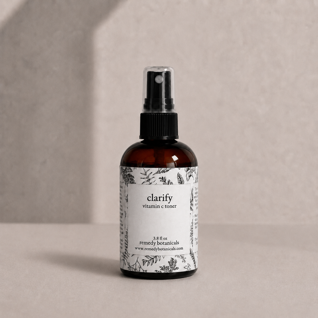 Remedy Botanicals Clarify in an amber plastic spray bottle on a soft beige background.