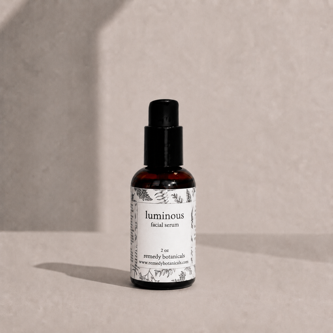Luminous in an amber plastic pump bottle on a soft beige background.