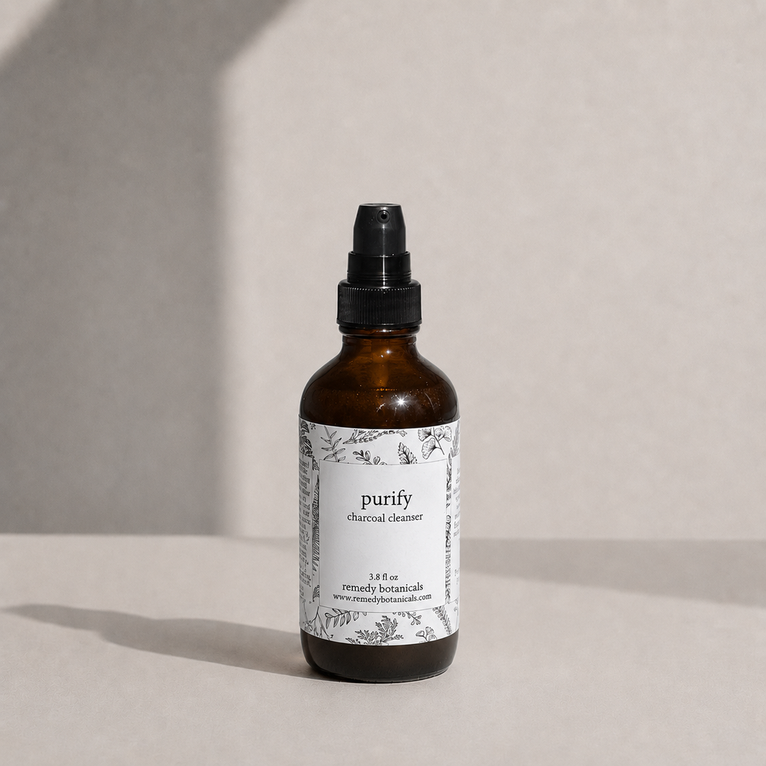 An amber glass bottle of purify on a soft beige background with natural light.