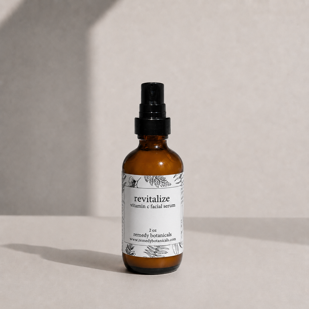An amber glass bottle of revitalize on a soft beige background with natural light.