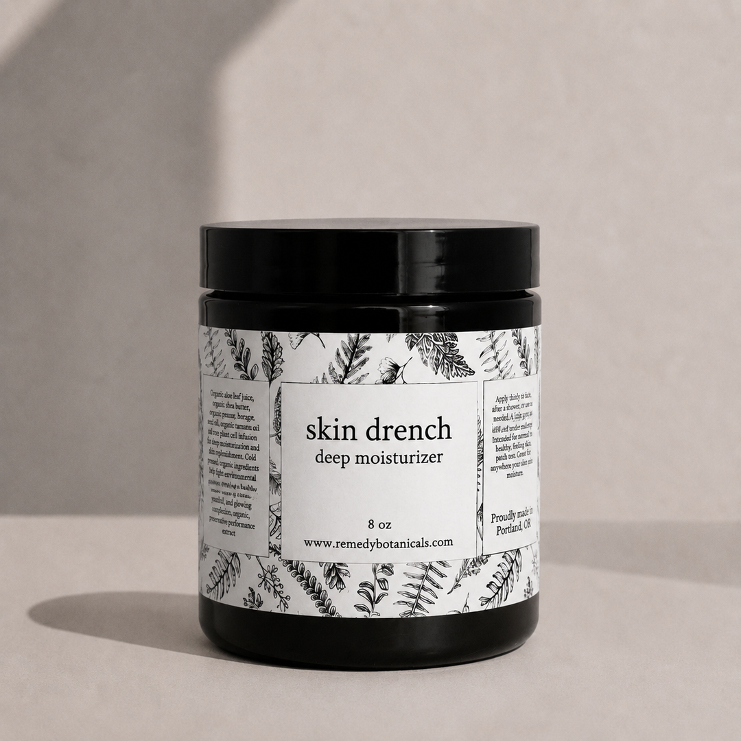 Jar of 'skin drench' deep moisturizer with botanical label on a neutral background