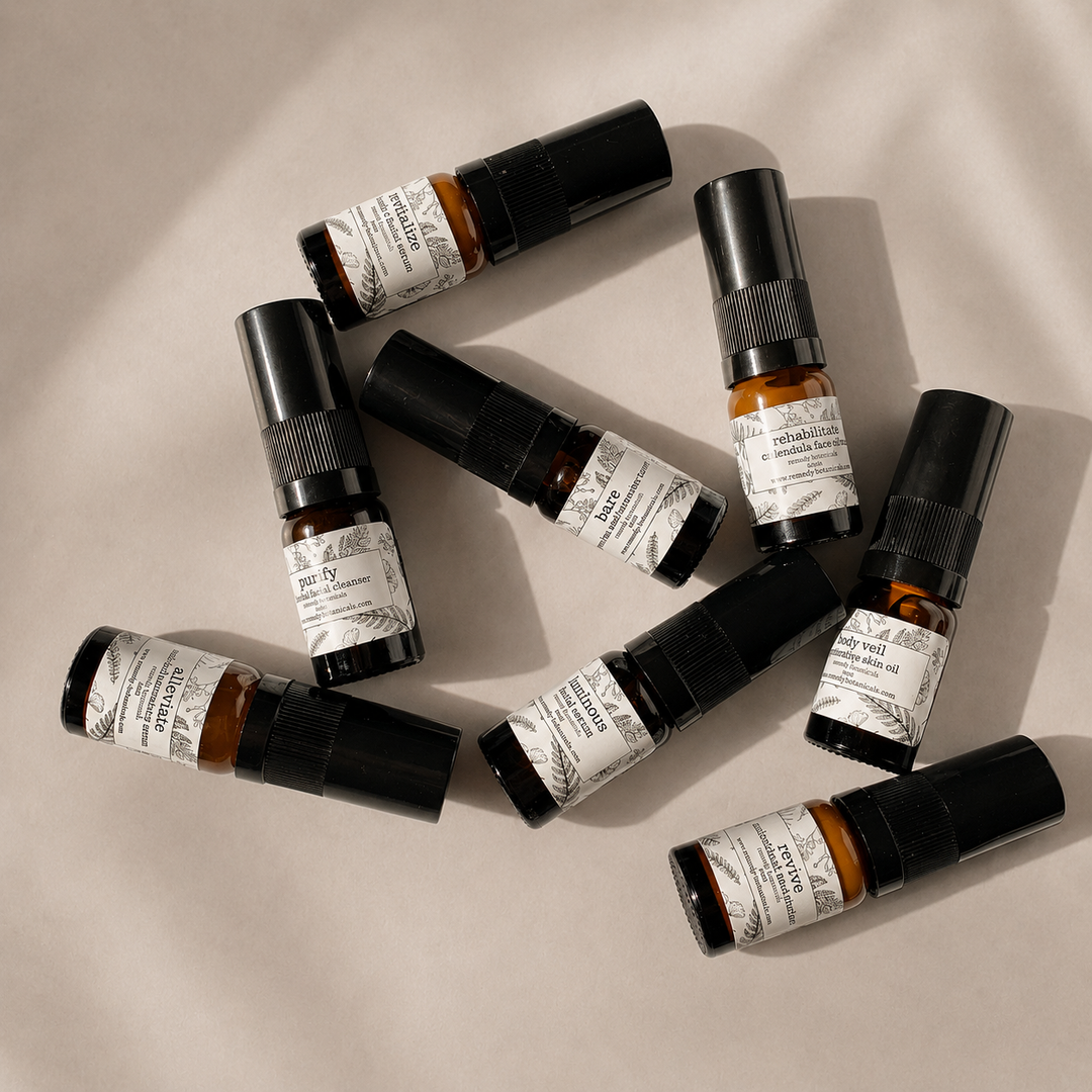 Multiple small plastic bottles with black caps on a white background