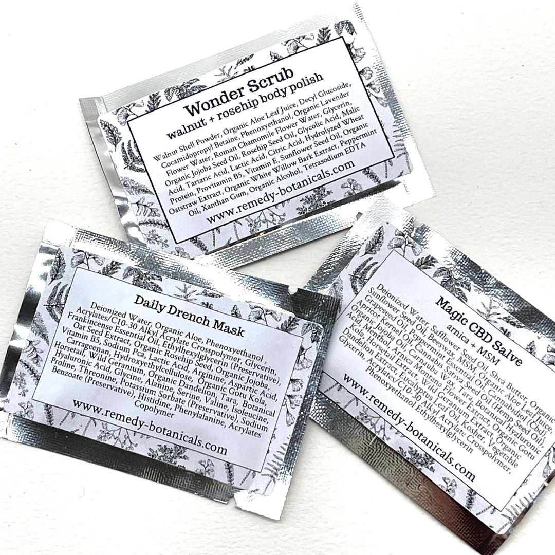 Three sample wrapped in white illustrated packaging, displayed on a clean white surface.